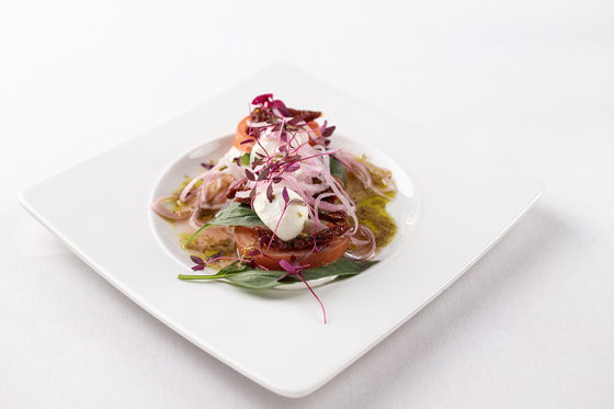 Image of a colourful wedding meal on a square plate.